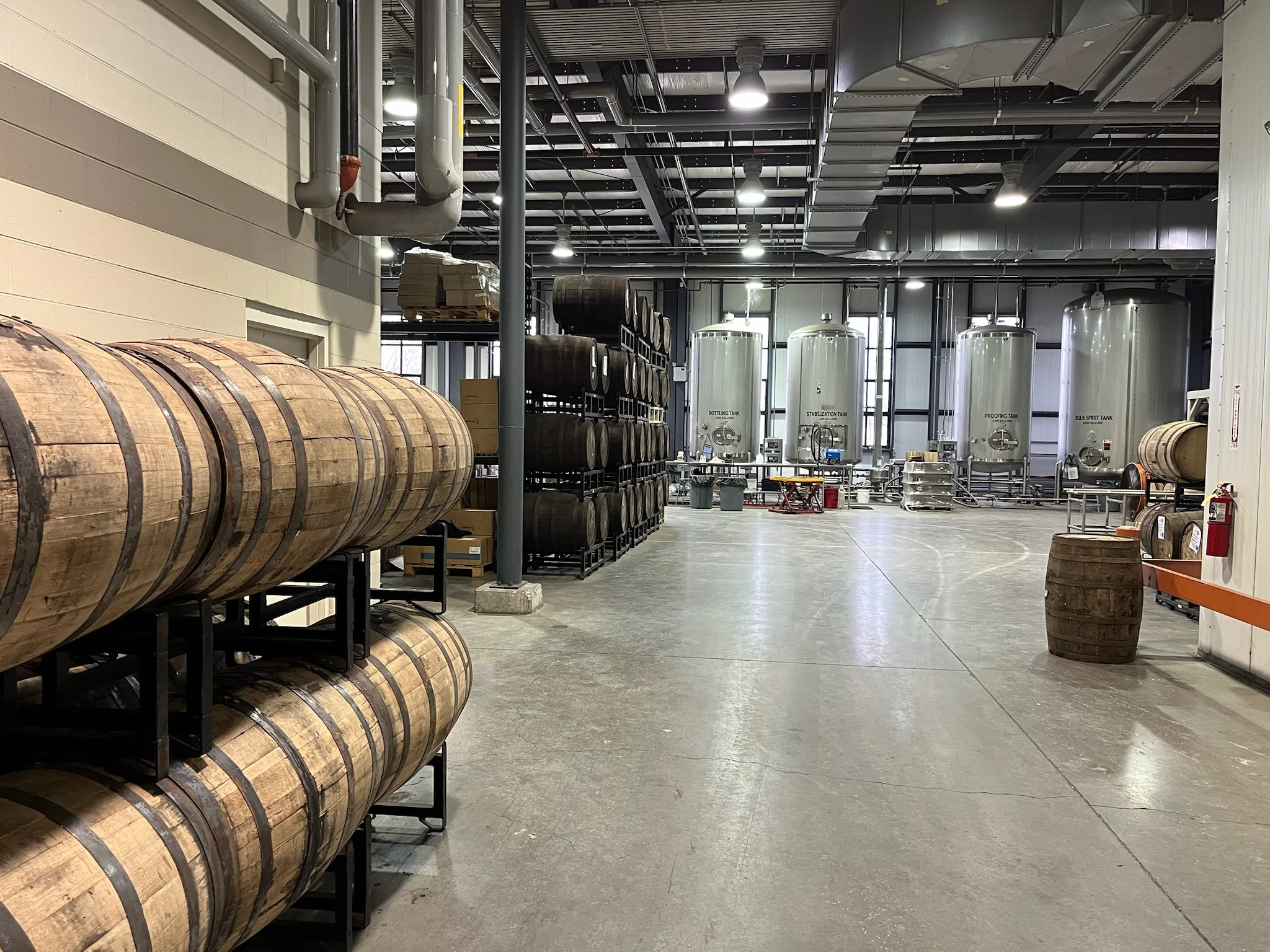 Inside a Kentucky bourbon distillery with barrels and equipment